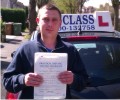 George with Driving test pass certificate