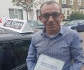 Manuel with Driving test pass certificate