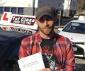 Daniel with Driving test pass certificate